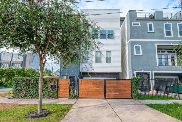 view of property with a fenced front yard and a gate