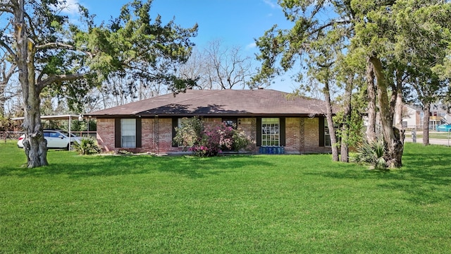 ranch-style house with a carport, a front lawn, and brick siding