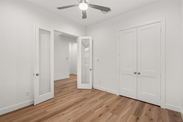 16174 Rustling Woods Rd, Conroe, TX 77302 - unfurnished bedroom featuring light wood-style floors, baseboards, a closet, and a ceiling fan