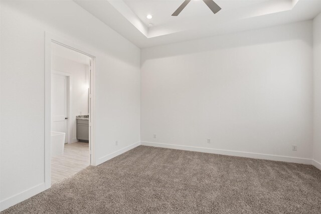 16174 Rustling Woods Rd, Conroe, TX 77302 - unfurnished room featuring light carpet, a raised ceiling, baseboards, a ceiling fan, and recessed lighting