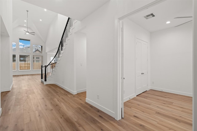 16174 Rustling Woods Rd, Conroe, TX 77302 - entrance foyer featuring stairway, light wood-style floors, lofted ceiling, a ceiling fan, and baseboards