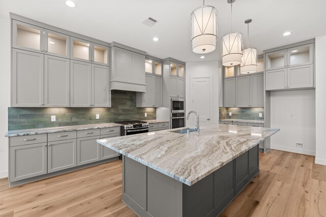 16174 Rustling Woods Rd, Conroe, TX 77302 - kitchen with appliances with stainless steel finishes, a sink, gray cabinetry, and recessed lighting