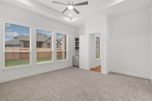 16174 Rustling Woods Rd, Conroe, TX 77302 - unfurnished bedroom with light colored carpet, baseboards, a ceiling fan, a tray ceiling, and recessed lighting
