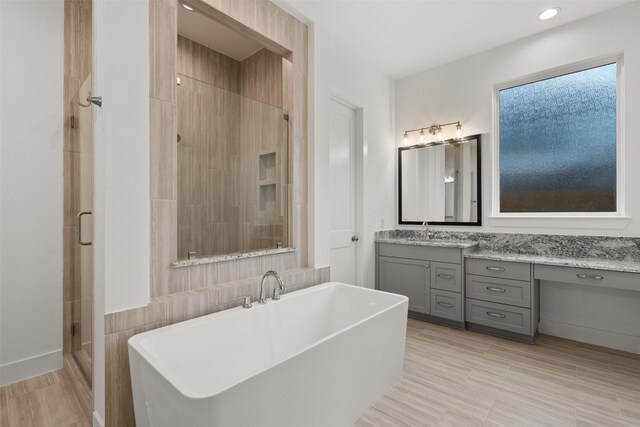 16174 Rustling Woods Rd, Conroe, TX 77302 - full bathroom with a stall shower, a freestanding bath, vanity, and recessed lighting