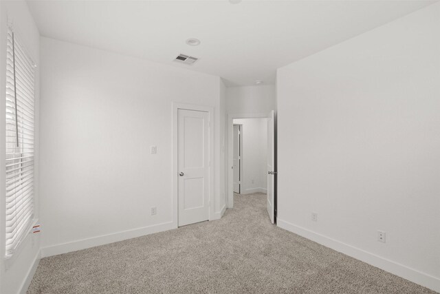 16174 Rustling Woods Rd, Conroe, TX 77302 - unfurnished bedroom featuring light colored carpet and baseboards