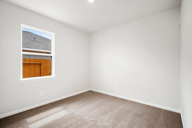 carpeted spare room with baseboards