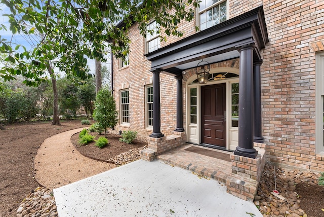 view of exterior entry with brick siding