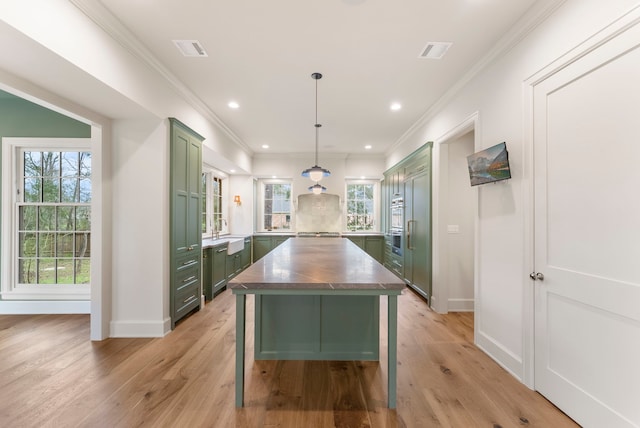 kitchen featuring green cabinetry, visible vents, light wood-type flooring, and butcher block countertops