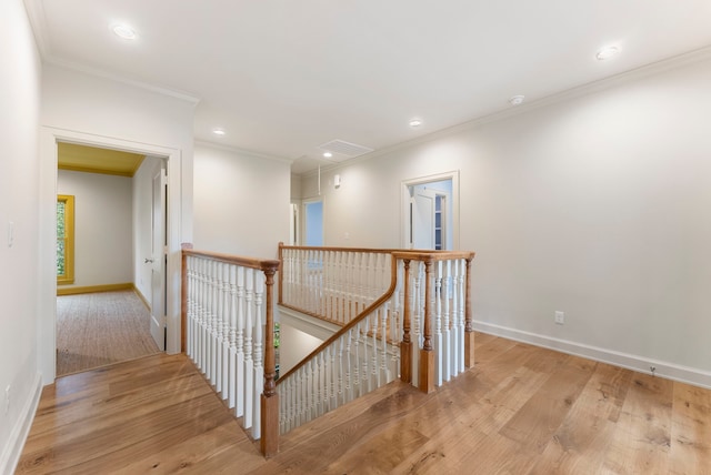 corridor with baseboards, an upstairs landing, and light wood-style flooring