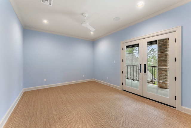 empty room featuring visible vents, french doors, crown molding, baseboards, and light colored carpet