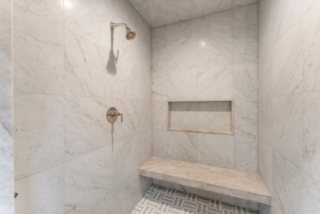 bathroom with a tile shower