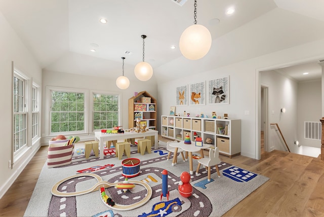 recreation room featuring vaulted ceiling, recessed lighting, and wood finished floors