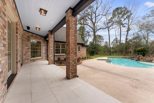 view of swimming pool with a pool with connected hot tub and a patio area