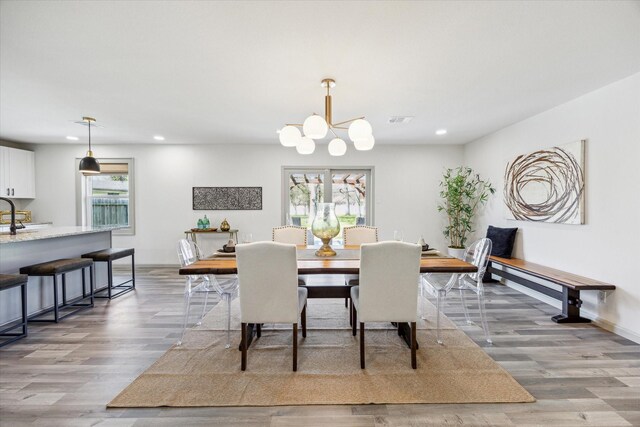 dining room featuring visible vents, baseboards, an inviting chandelier, light wood-style flooring, and recessed lighting