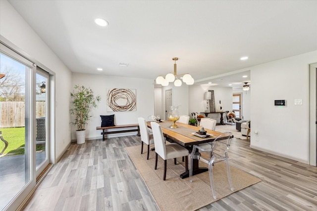 dining space featuring an inviting chandelier, recessed lighting, baseboards, and light wood finished floors