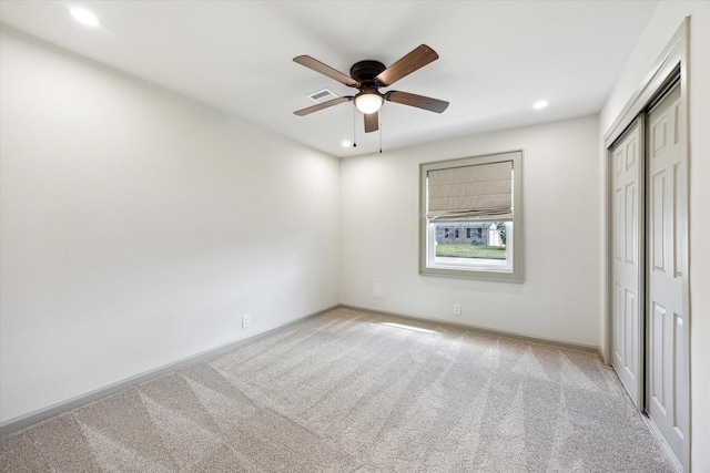 unfurnished bedroom with visible vents, recessed lighting, a closet, carpet flooring, and baseboards