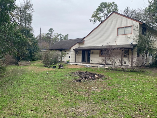 back of property featuring a lawn and a patio area