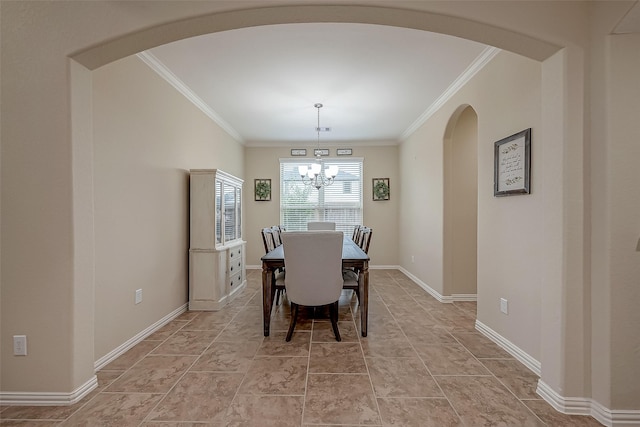 dining area with arched walkways, baseboards, crown molding, and an inviting chandelier