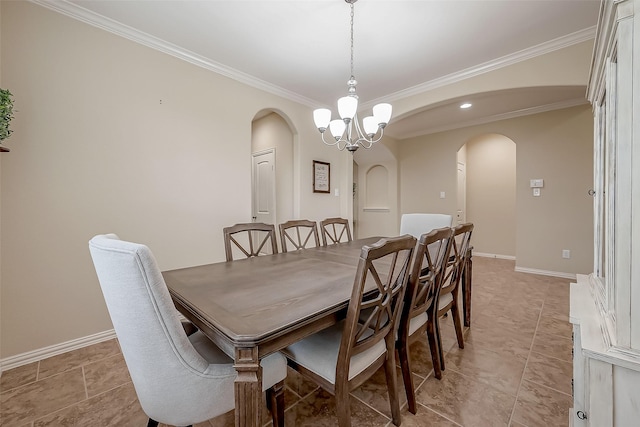 dining room with baseboards, arched walkways, a notable chandelier, and crown molding