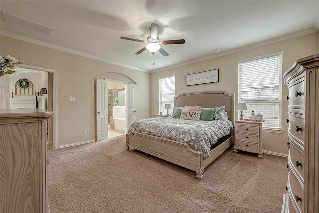 bedroom featuring connected bathroom, crown molding, baseboards, ceiling fan, and light colored carpet