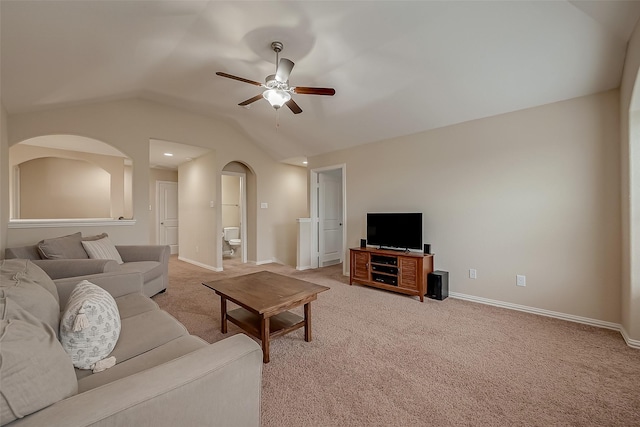 living room with a ceiling fan, lofted ceiling, light colored carpet, and baseboards