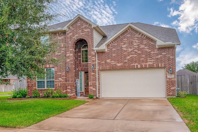 traditional-style home with brick siding, a front lawn, a garage, and fence