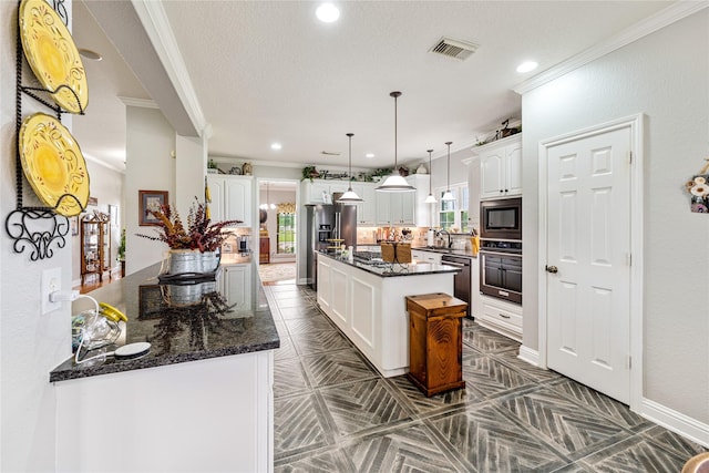 kitchen with visible vents, wall oven, built in microwave, high end fridge, and white cabinetry