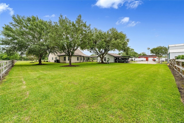 view of yard featuring a carport and fence