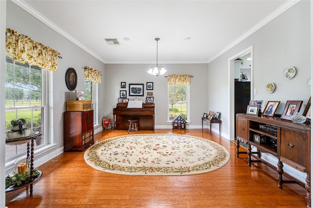 dining room featuring visible vents, ornamental molding, baseboards, and hardwood / wood-style flooring