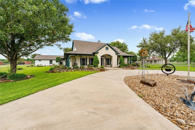 view of front of property with concrete driveway and a front yard