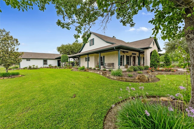 back of house featuring a patio, a lawn, ceiling fan, and a chimney