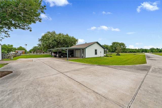 view of side of home with a carport and a yard