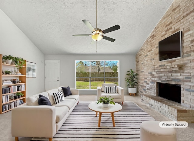 living area featuring a ceiling fan, a textured ceiling, carpet flooring, a fireplace, and vaulted ceiling