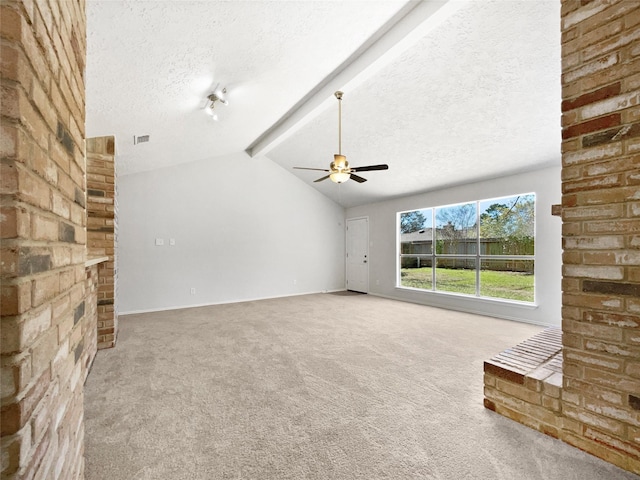 unfurnished living room with ceiling fan, vaulted ceiling with beams, carpet, and a textured ceiling