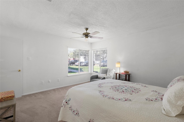 bedroom with baseboards, a textured ceiling, a ceiling fan, and carpet floors