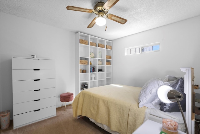 carpeted bedroom featuring a textured ceiling and ceiling fan