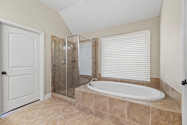 full bath with tile patterned floors, a stall shower, a garden tub, and vaulted ceiling