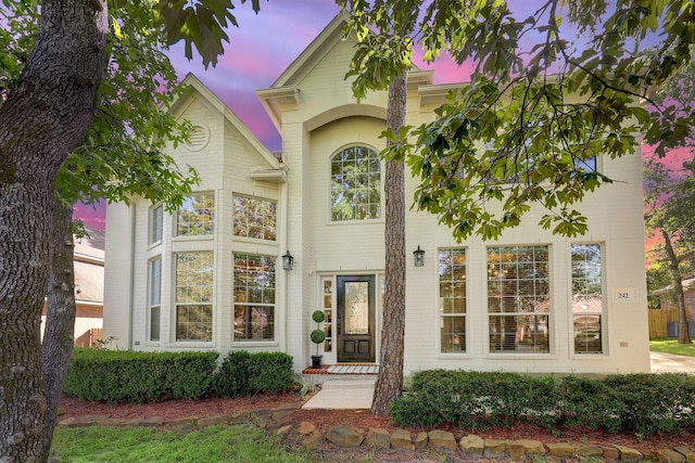 exterior entry at dusk with brick siding