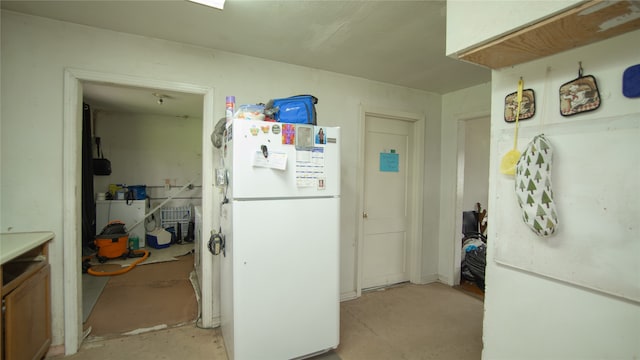 602 Riveredge Dr, Richmond, TX 77406 - kitchen featuring unfinished concrete flooring and freestanding refrigerator