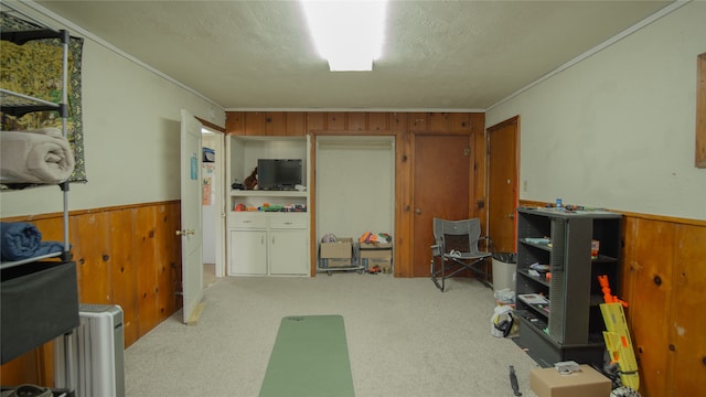 602 Riveredge Dr, Richmond, TX 77406 - interior space with a wainscoted wall, wood walls, a textured ceiling, and crown molding