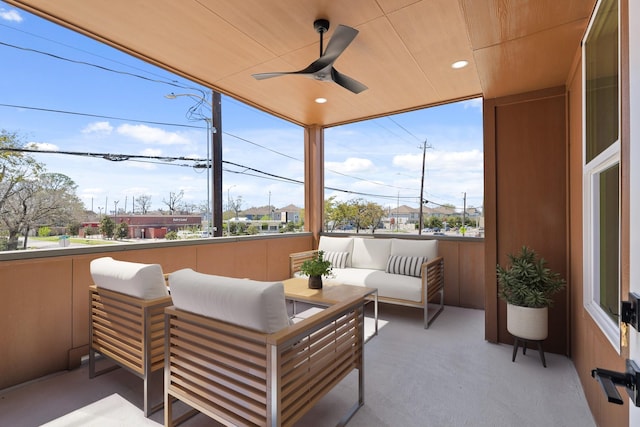 sunroom featuring a ceiling fan