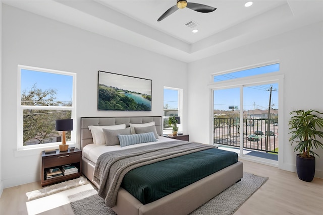 bedroom with access to exterior, visible vents, baseboards, recessed lighting, and wood finished floors