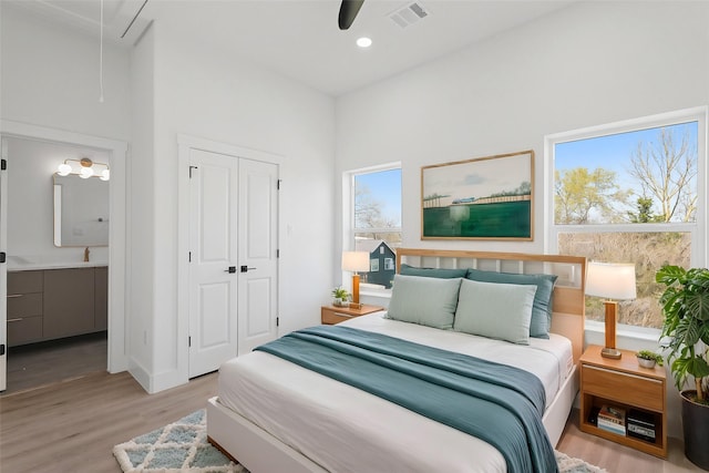 bedroom featuring visible vents, wood finished floors, recessed lighting, a closet, and attic access