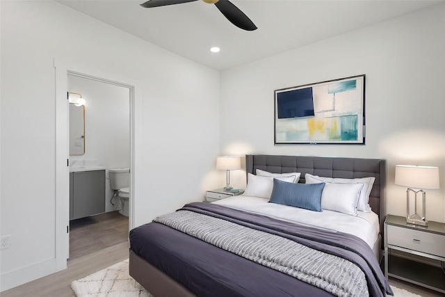 bedroom with a ceiling fan, recessed lighting, wood finished floors, and ensuite bathroom