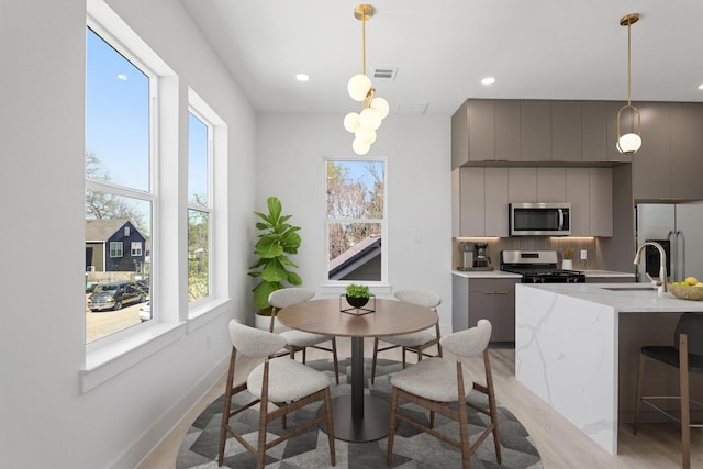 dining area featuring recessed lighting, baseboards, visible vents, and light wood finished floors