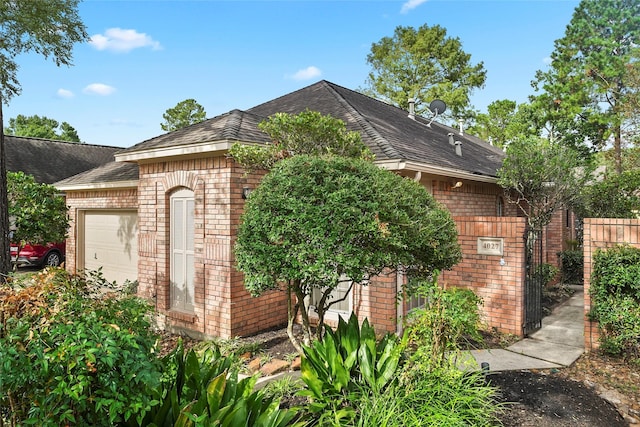 view of outbuilding with a garage and fence