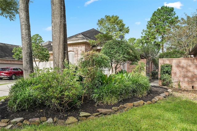 view of yard featuring a garage and fence