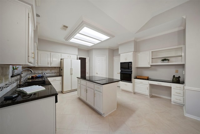 kitchen with visible vents, dark countertops, black appliances, and built in desk