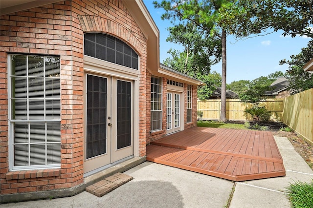 exterior space with french doors and a fenced backyard