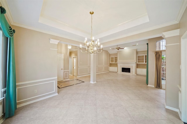 interior space featuring a decorative wall, a fireplace, and a tray ceiling